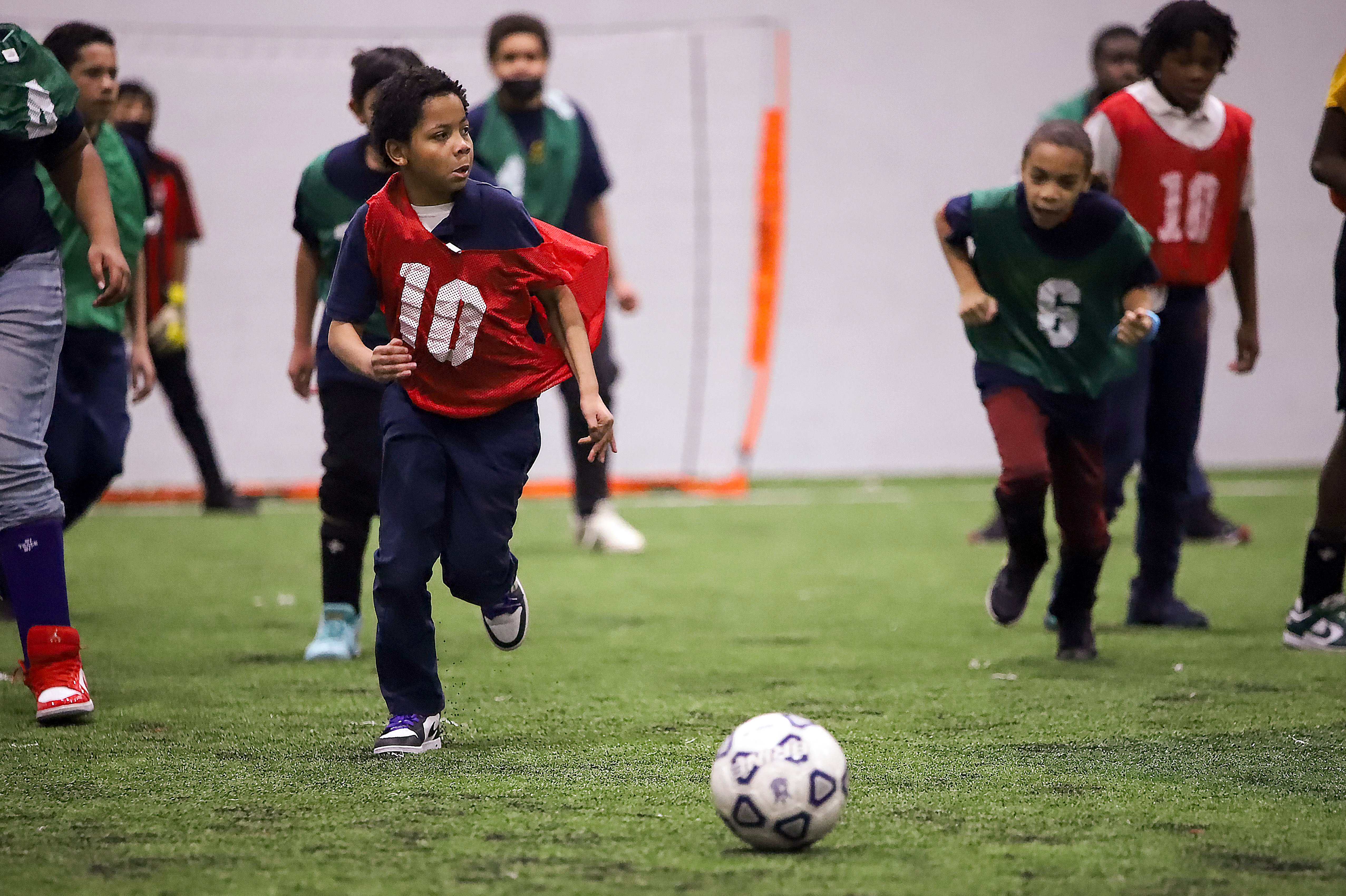 Elementary school children race towards the ball during a soccer tournament at the Pullman Community Center on February 8, 2023. The athletes were on a field trip with their Chicago Public School. (Photo by Kelly Jankowski)